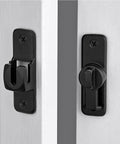 Matte Black 90 And 180 Degree Barn Door Latch Lock, Zinc Alloy Flip Latch For Cabinets, Bathrooms, Barns, Gardens, Windows And Small Pet Cages, Right Angle Door Lock, Easy Install No Brainer Security For Any Home showing installed view on white doors.