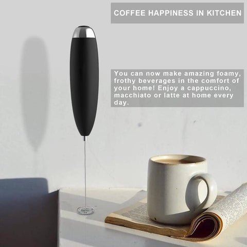 Handheld Electric Milk Frother Wand for Coffee at Home with a black handle next to a cup, battery operated for barista-grade foam.