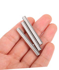Hand holding stainless steel dowel pins set of 100 for pro grade precision positioning in machinery, electronics, automotive projects.