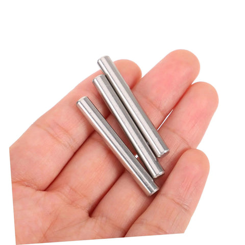 Hand holding stainless steel dowel pins set of 100 for pro grade precision positioning in machinery, electronics, automotive projects.