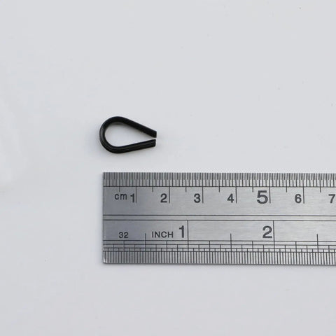 Rock Solid 304 Grade Stainless Steel Thimble Fits 1 16 Inch Wire Rope Cable shown next to ruler for size reference.
