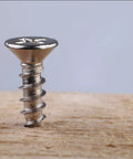 Top Shelf Gauge 4 By One Half Inch 304 Stainless Steel Wood Screws with a Smooth Phillips Drive standing on wood.