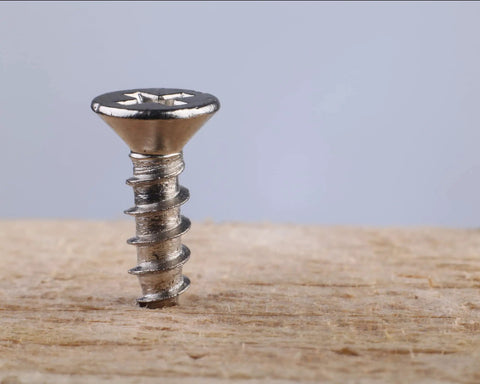 Top Shelf Gauge 4 By One Half Inch 304 Stainless Steel Wood Screws with a Smooth Phillips Drive standing on wood.