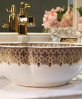 USZWBY Bathroom Sink, Countertop Basin Ceramic Sink with gold and brown floral design, round shape, stylish bathroom decor.