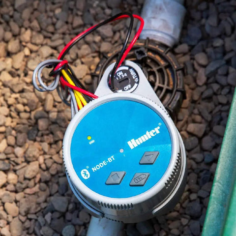 Bluetooth Battery Powered Sprinkler Controller With Solenoid, Waterproof Irrigation Timer installed on rocky ground