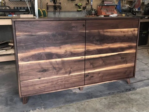 Wooden cabinet with a natural finish adjacent to tools, showcasing the effects of Furniture Wood Oil 100% Natural Finish And Restore For Cabinets Tables And Floors VOC Free 8oz Bottle Polymerizing Curing Oil That Delivers A Boss Matte Black Finish No Fuss Use Lightly Scented FDA Food Contact Safe Made In USA.