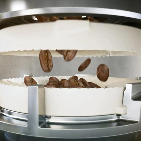 Top Shelf Automatic Espresso Brewer With Sturdy Built In Bean Mill showing freshly roasted coffee beans falling into the grinder.