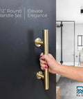 Dope 12 Inch Brushed Brass Gold Barn Door Handle Kit With Solid Aluminum Pulls And Flush Handles Heavy Duty Sliding Door Hardware 1 Door Pack Includes Screws And Protective Pads shown installed on a black interior door with a hand pulling it.
