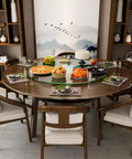 Kickass Heavy Duty Lazy Susan Turntable With Thick Tempered Glass Top and Stainless Steel Bearings on a dining table filled with food.