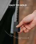 Hand holding matte black concealed handle from 10 Pack Finger Edge Pulls For Cabinets With 76mm Hole Center And 102mm Overall Length