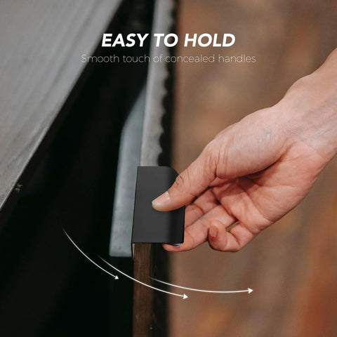 Hand holding matte black concealed handle from 10 Pack Finger Edge Pulls For Cabinets With 76mm Hole Center And 102mm Overall Length