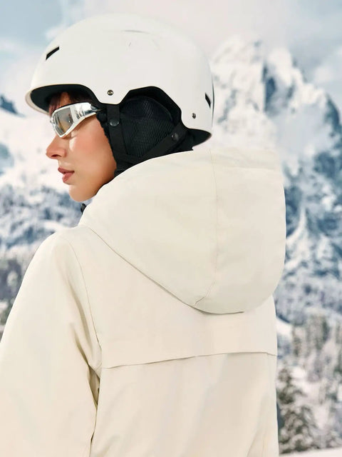 Side view of Women's One Piece Ski Suit Snow Suit Winter Waterproof Outdoor Snowsuit Jumpsuit with hood in snowy mountains.