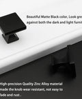 Twelve Pack Matte Black Square Cabinet Knobs Solid Zinc Alloy Drawer Pulls Heavy Duty Hardware on light and dark surfaces.