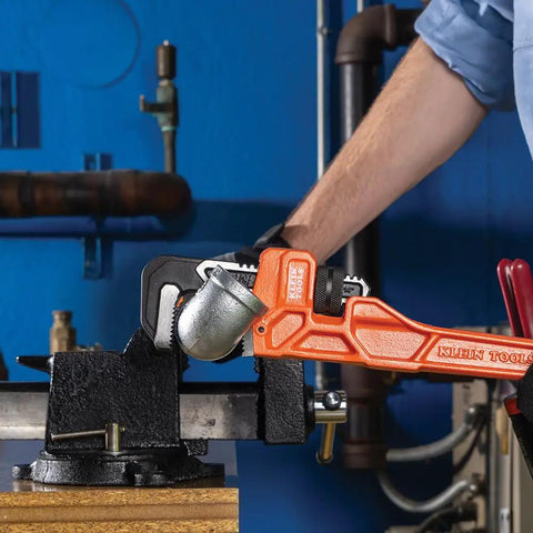 14 Inch Cast Iron Pipe Wrench Heavy Duty Adjustable Plumbing Wrench gripping a pipe in a workshop setting.
