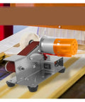 Compact Mini Electric Belt Sander For Desktop DIY Projects on wooden surface showcasing motor and sanding belt.
