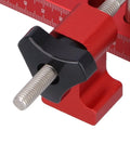 Close-up of Dead Nuts On 90 Degree Woodworking Corner Clamping Jig with adjustable screw and metric scale in red aluminum.