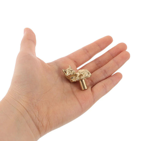 Person holding Dope Cat Shaped Brass Cabinet Door Knob With Smooth Finish, Vintage Gold Cabinet Pull For Kitchen And Home Decor.