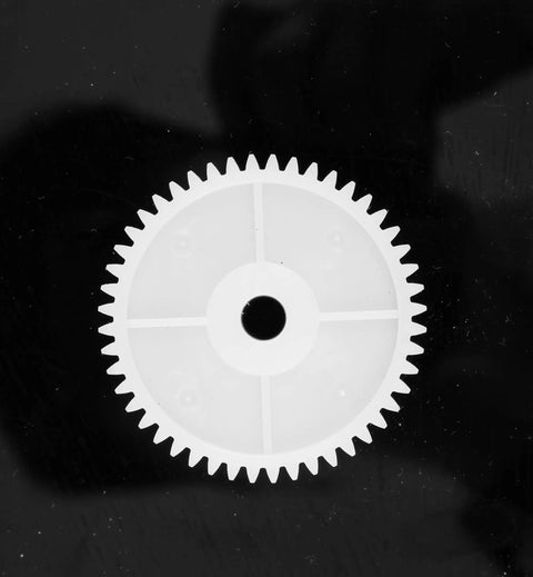 Large gear from 550 Gear Box Set For Kids Must Have Ride On Car Replacement Gears Kit, shown on black background for smooth gearbox operation.