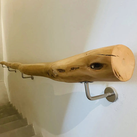 Built Like A Tank Adjustable Solid Wood Handrail Kit with sleek steel brackets mounted to a wall along a staircase.