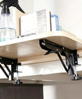 Heavy Duty Foldable Shelf Brackets For Desk Extension Clamps Punch Free Tabletop Mount Black Steel shown supporting a wooden shelf.
