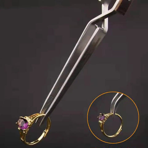 Precision Cross Tip Soldering Tweezers For Hot Welding Electronics Circuit Board Repair Clamps with a golden ring grasped securely.