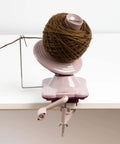 Purple Yarn Ball Winder For Knitting And Crocheting, Easy To Use Tool That Winds Hanks Into Center Pull Cakes Up To 100 Grams, Works With Lace To Worsted Weights, Makes Quick Mess Free Yarn Prep For Projects. Clamp-mounted yarn ball winder with yarn cake on table