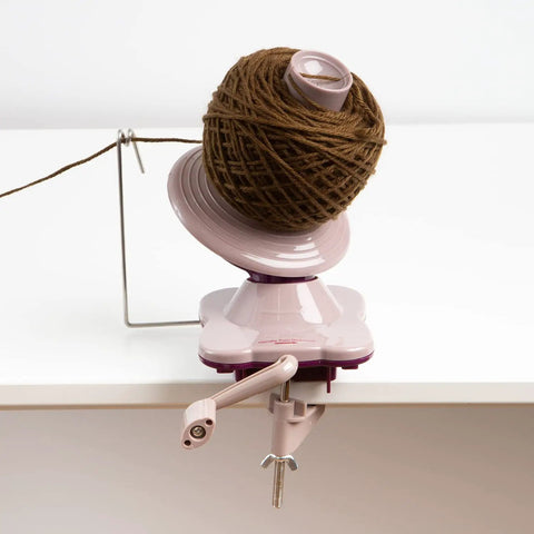 Purple Yarn Ball Winder For Knitting And Crocheting, Easy To Use Tool That Winds Hanks Into Center Pull Cakes Up To 100 Grams, Works With Lace To Worsted Weights, Makes Quick Mess Free Yarn Prep For Projects. Clamp-mounted yarn ball winder with yarn cake on table