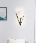 Modern Black Acrylic Wall Sconce Minimalist Bedroom Bedside Lamp With Uniform Soft Glow For Living Room Decor and Creative Lighting Fixture with unique triangular design.