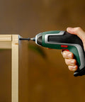 Close-up of a hand using a power drill with the 810 Piece M3 Metric Screw Assortment Kit for assembling wooden furniture.
