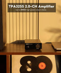 TPA3255 Class D Stereo Amplifier 300W Per Channel X2 on a shelf with speaker, laptop, and records