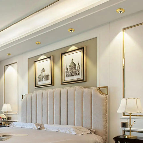 12 Pack Badass Durable Brass And Copper Finish Recessed LED Ceiling Downlights featuring slick baffle trim illuminating a bedroom decor.