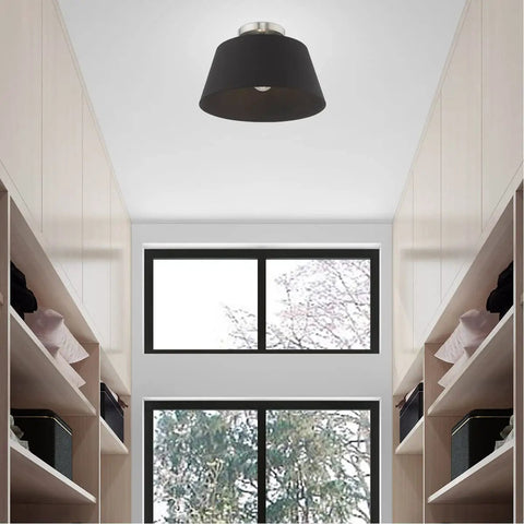 One Light Brushed Nickel Ceiling Mount Fixture With Black Accents in hallway, modern sleek design with black drum shade.