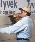 Person using a 5 To 8 Inch Exposure Facing And Overlap Gauge Set For One Person Siding Installations with power tool