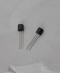 Two TO-92 package transistors from Go-To Transistor Assortment Kit 100 Pcs TO-92 NPN BC550C PNP BC560C for Audio Amplifiers and Signal Processing.