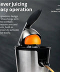 Close-up of 350W Electric Citrus Juicer With Stainless Steel durable construction squeezing an orange for juice extraction.