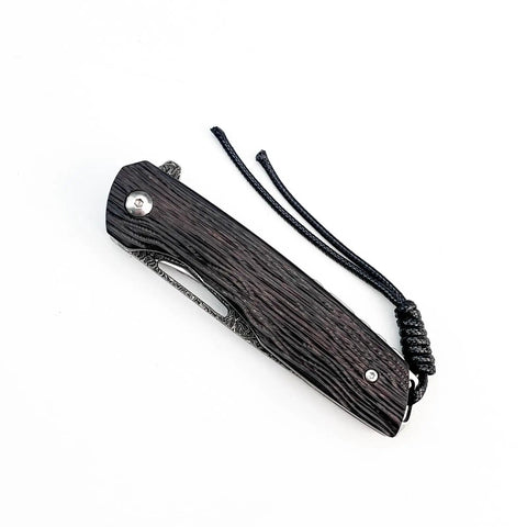 Folded view of Damascus Steel Folding Pocket Knife with 3.35 Inch Blade and Rosewood Handle showing closed position and lanyard.