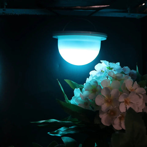 Glowing 4 Pack LED Under Table Light for Parties, RGB color changing uplighting on a floral arrangement, no cables, party ready