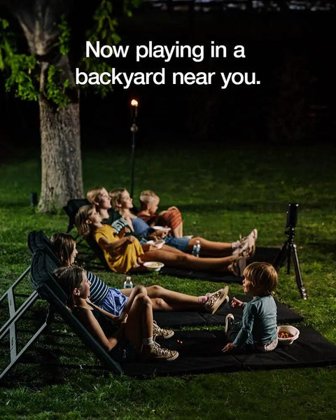 Family enjoying backyard movie night on Adjustable Chaise Lounge With 2 Inch Foam Pad And Portable Carry Case, durable frame.