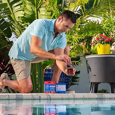 Person testing water with Swimsuit Ready 3 Way Water Test Kit For Swimming Pool Checks Bromine Chlorine And Ph Levels Instantly.