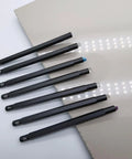 Seven Piece Hardness Test Kit For Rocks And Gems With Portable Scratch Pen Set 3 To 9 Mohs Includes Durable Storage Box For Easy Carry Grab And Go Mineral ID For Industrial Use And Gem Jade Testing. Seven Mohs scratch pens laid out on a flat surface.
