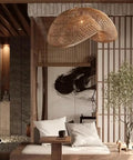 YAXDQUW Irregular Shaped Rattan Pendant Light Hand Woven Wicker Hanging Ceiling Lamp in a cozy living room setting.