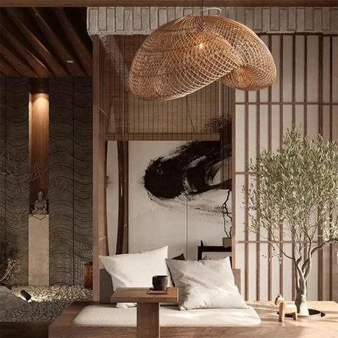 YAXDQUW Irregular Shaped Rattan Pendant Light Hand Woven Wicker Hanging Ceiling Lamp in a cozy living room setting.