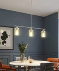 Three Light Modern Chandeliers For Kitchen Island Lighting In Brushed Nickel With Clear Glass Pendants over round dining table