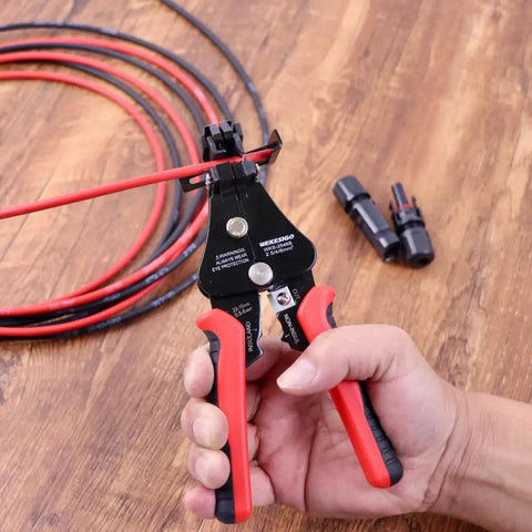 All In One 3 In 1 Adjustable Wire Stripper Tool with Automatic Solar Cable Stripper held by hand next to cables