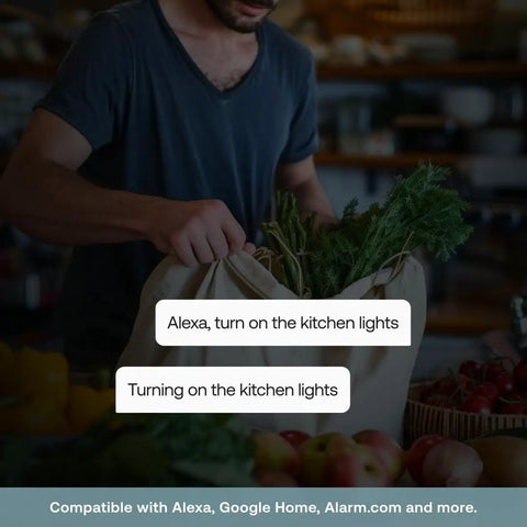 Man using Game Changing Smart Dimmer Switch with voice commands while holding a bag of groceries in kitchen.