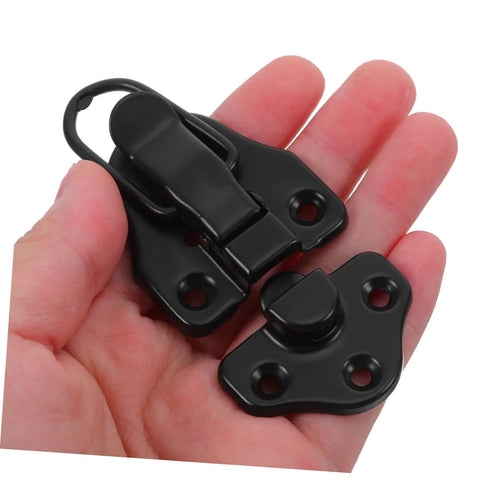Hand holding black 8 Piece Metal Buckle Kit With Duckbilled Toggle Latch Antique Box Latch Hardware for easy fastening