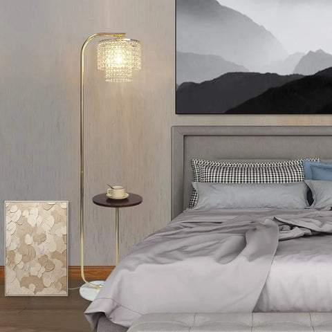 Arc Crystal Floor Lamp With Marble Base And Integrated Table beside a bed in a modern bedroom setting