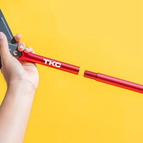 TKC 9-inch perforated pizza peel side view with red aluminum handle and threaded connector