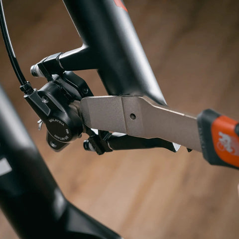 Professional Hydraulic Disc Brake Caliper Piston Press Tool Wrench with wedge design in use on bike caliper service.