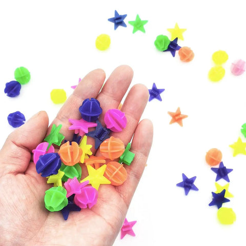 Hand holding colorful star and round plastic spoke beads from 72 Pack Colorful Bike Spoke Beads Kid Friendly Clip On Plastic Beads